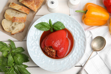 Delicious stuffed pepper served on white wooden table, flat lay