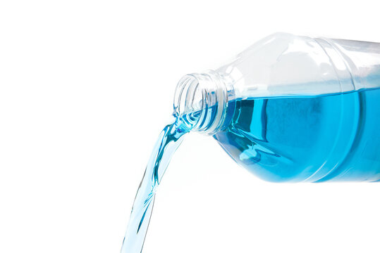 Pouring Of Blue Windshield Washer  Fluid On White Background