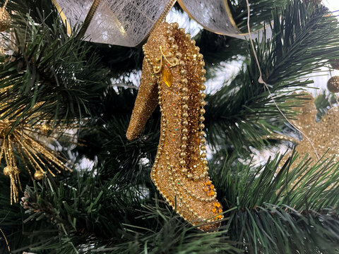 Christmas toy for the Christmas tree in the form of a golden slipper