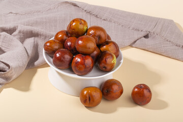 Jujube or Monkey apple fruit isolated on yellow background.