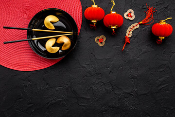 Chinese New Year tabble setting with fortune cookies and golden chopsticks