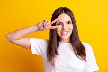 Photo of young pretty girl have fun fooling show peace cool v-symbol isolated over yellow color background