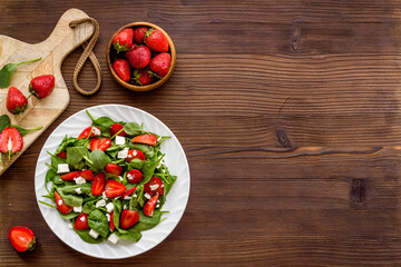 Vegetarian diet - green spinach salad with strawberry and goat cheese