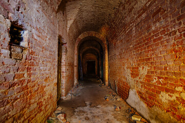 Vaulted red brick dungeon under old castle