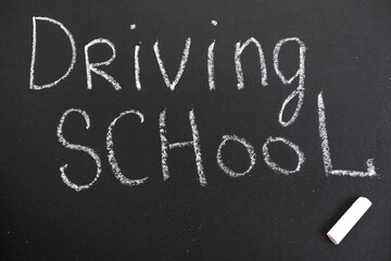 Fototapeta premium Driving school chalkboard, Educational and Creative composition with the Driving school caption. toy car model.