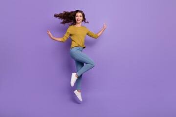 Full length portrait of energetic pretty lady raise hands enjoy free time isolated on violet color...