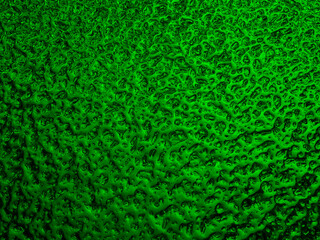 Bright green winter background. The surface of ice frozen on the window pane. An abstract pattern with a metallic sheen, like streams of mercury. Rich vivid wallpaper. Close-up