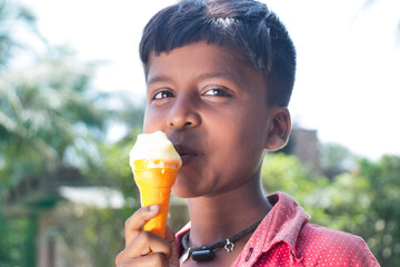 Portrait of a young rural boy having ice cream