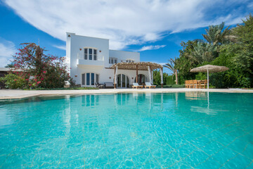 Fototapeta na wymiar Swimming pool at at luxury tropical holiday villa