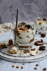 Vertical composition. Delicious cheese dessert with chocolate chips on a light background. Light, healthy breakfast