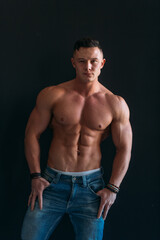 Fototapeta premium young man, brutal appearance, with a beautiful torso, bodybuilder, in the studio