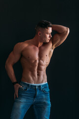 Fototapeta premium young man, brutal appearance, with a beautiful torso, bodybuilder, in the studio