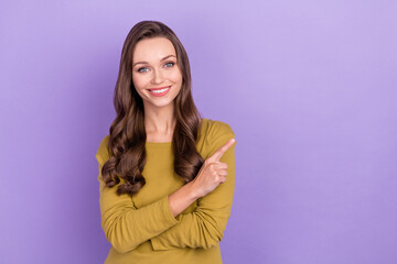 Fototapeta premium Photo of charming cheerful lady direct finger empty space proposition beaming smile isolated on violet color background