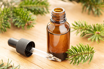 Fir essential oil in bottle still life. Herbal remedies