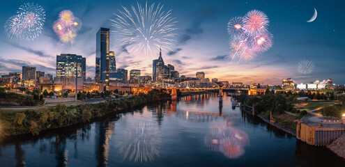 Nashville skyline during blue hour with river front and fireworks