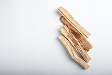 Palo Santo bars close-up and copy space. Ritual cleansing with sacred ibiocai, meditation, aromatherapy with incense and candles..