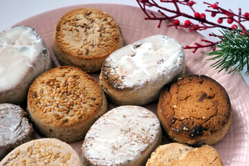 A plate of traditional Spanish Christmas biscuits. Many different Estepa, Polvoron, Mantecado, Nevaditos and a Christmas ornament