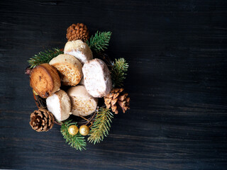 Fototapeta na wymiar Spanish Christmas sweets Estepa, Polvoron, Mantecado, Nevaditos, fir branches and cones