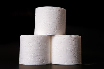 Top view of unrolled toilet paper at black background