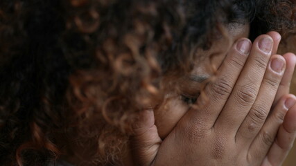 Woman filled with regret covering face with hands