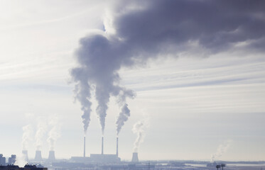 smoke from the warming pipes in big city and air pollution