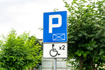 road sign with disabled parking space designation