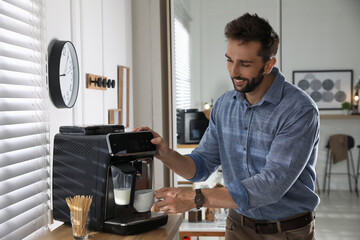 Man preparing fresh aromatic coffee with modern machine in office - obrazy, fototapety, plakaty