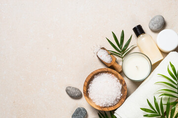 Spa background. Cosmetic product, towel and sea salt at stone table. Anti age, beauty, selfcare.
