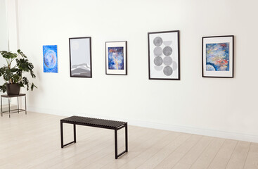 Bench and beautiful paintings in art gallery