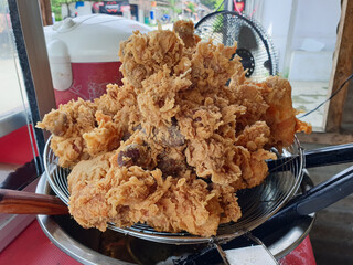 Crispy fried chicken, freshly removed from the frying pan.