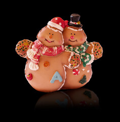 Two snowmen isolated on a black background.