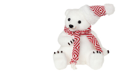 Polar bear with red scarf and hat isolated on white.