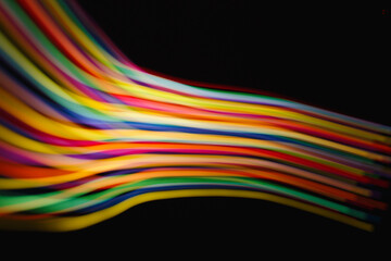 Colored lines of light on a black background.