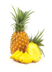 Whole fresh ripe pineapple fruit and pineapple fruit slices isolated on white background. 