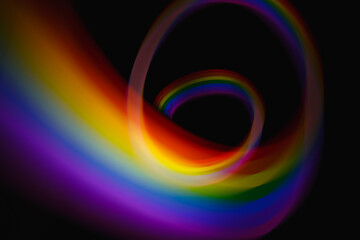 Blurred light rainbow lines. Colored streaks of light.