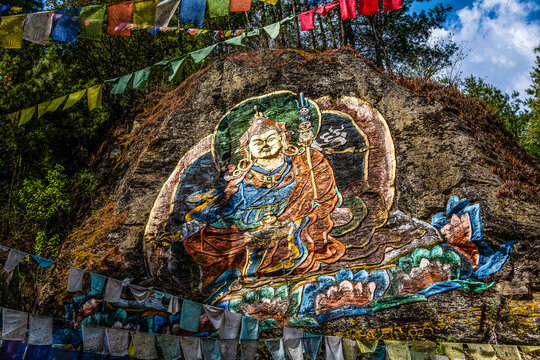 Colorful image of Guru Rinpoche op a rock near Tango Goemba monastery in Bhutan, Asia