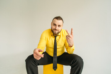 young man, business, sociable speaker, businessman, in a suit with a yellow shirt, in the studio on...