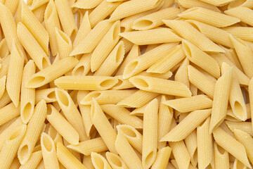 Pennette rigate. Background of raw pasta.