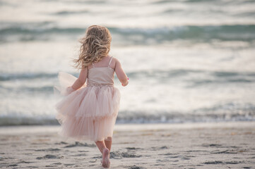 A Young Girl Kid Child Dancing Jumping Walking Running in a Pretty Pink Dress Water Sand Sunset Sun Sun light Beach Horizon Fun Get Outside Childhood Unplugged