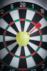 Concept achieving goal.Achieving goals in business and life.Dartboard with dart stuck right bullseye.