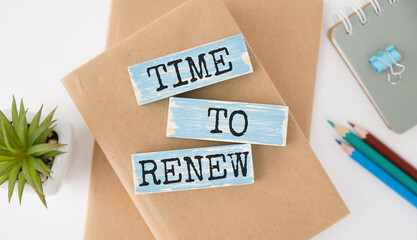time to renew text on a wooden cubes on a white background