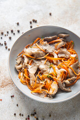 oyster mushrooms salad and Korean carrots pickled mushroom healthy meal food snack on the table copy space food background rustic top view