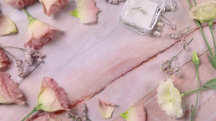 Copy space between pink flowers on a pink marble table top view - Powered by Adobe