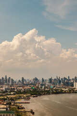 Obraz premium Bangkok, Thailand - May 13, 2021 : Beautiful sky and cloud view of Bangkok with skyscrapers along Chaopraya river in the afternoon. Selective focus.