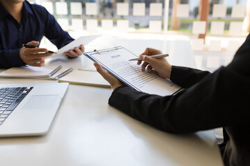The manager reads the resume and is interviewing the new employee. Business consultant consulting concept.