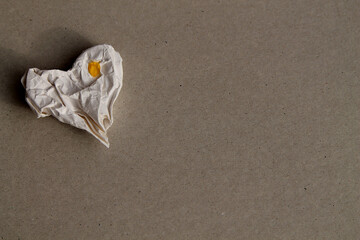 Paper heart, close-up, background image.
Heart made of crumpled paper