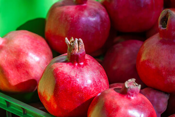 Ripe pomegranates on the market counter