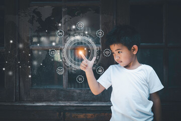 Asian boy wearing a white t-shirt Standing with your fingers touching the buttons of modern technology. for use in education in the digital world online. Children with education and technology.