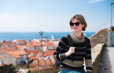 Fototapeta premium Holiday portrait of a smiling 30 year old white woman at the seaside, Piran, Slovenia