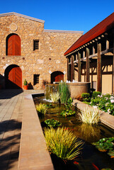 A winery in the Napa Valley is built in the Spanish Mission style with a beautiful courtyard surrounded by stone walls